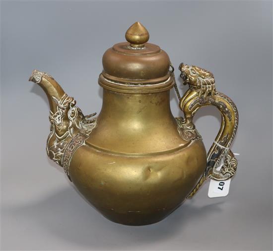 A 19th century Tibetan brass and silver overlaid teapot H. 29cm